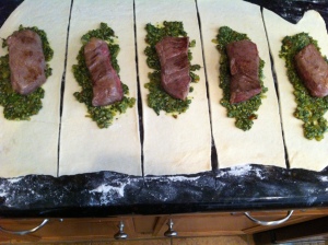 Meat and pesto placement on pastry.